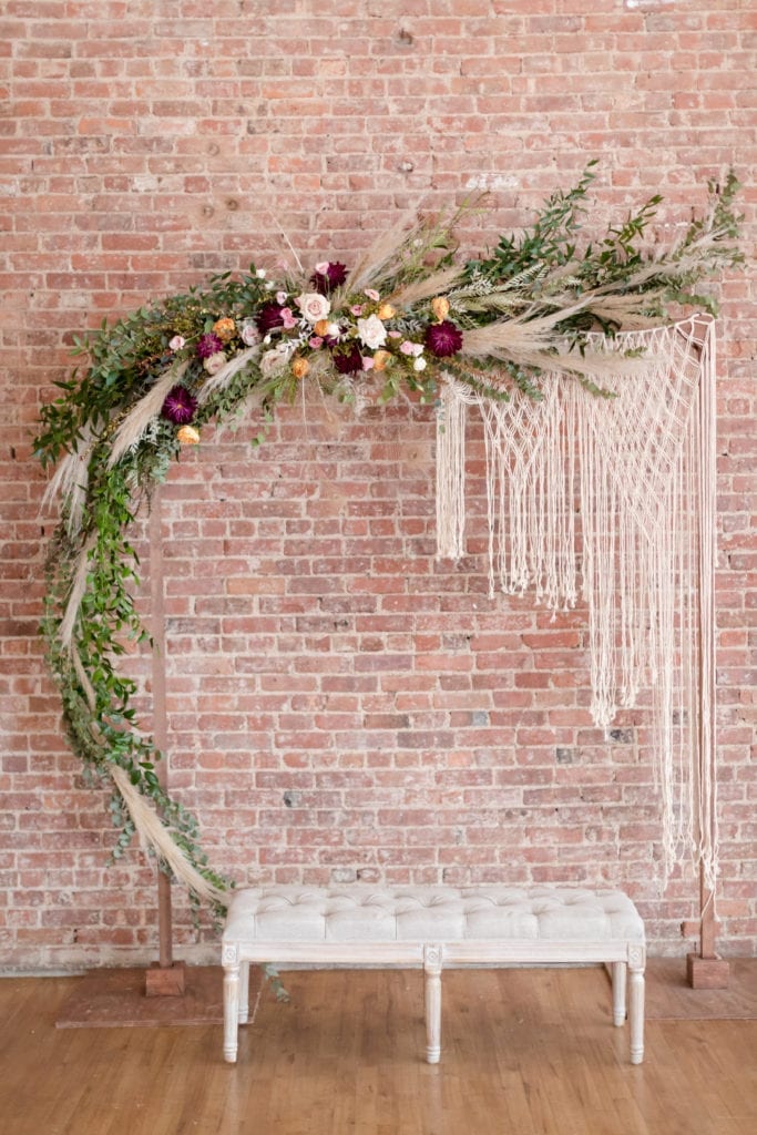 boho floral wedding arch; boho wedding bench