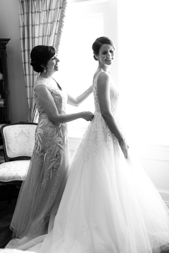 mother of the bride helping bride get ready, Enaura Bridal wedding gown