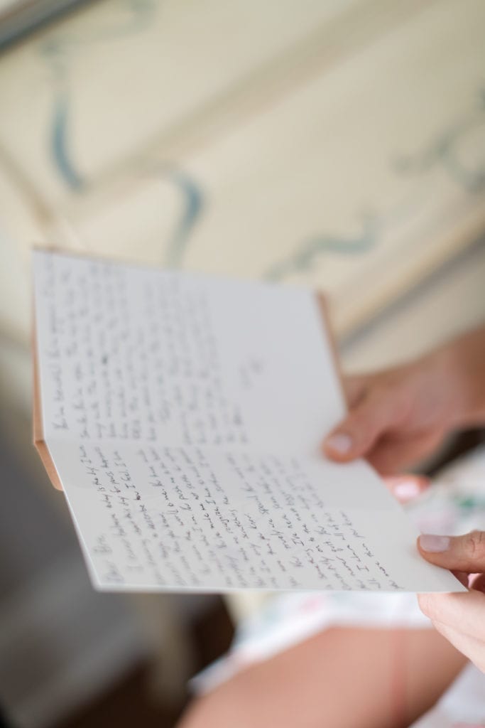 bride reading letter from husband on wedding day