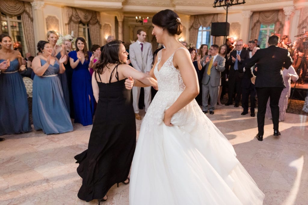 bride and groom dancing with guests