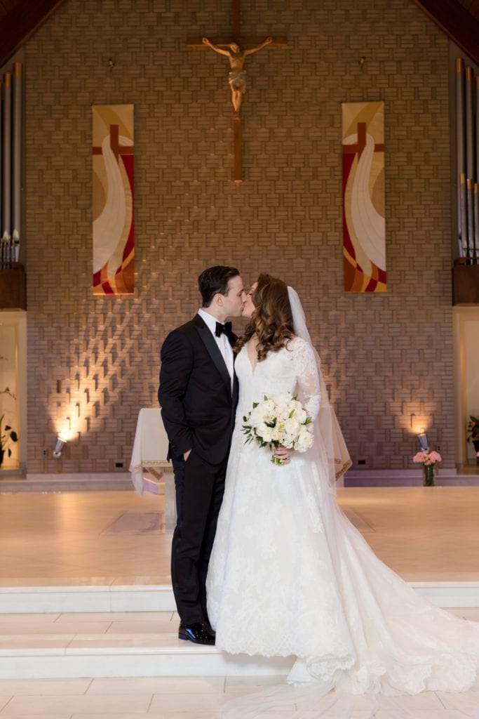 bride and grooms embrace, L'Fay Bridal veil