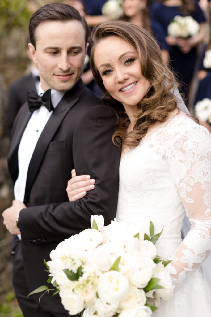 closeup shot of bride and groom, lace sleeve Pronovias wedding gown