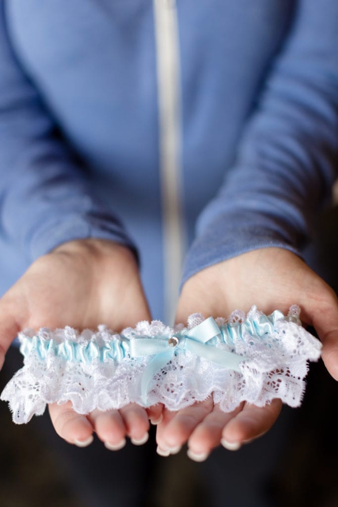 groom holding garter