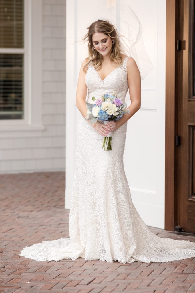 bride with veil blowing in the wedding, allure couture wedding dress