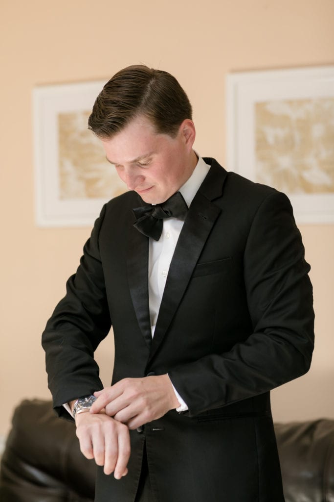 groom on his wedding day, groom putting on watch