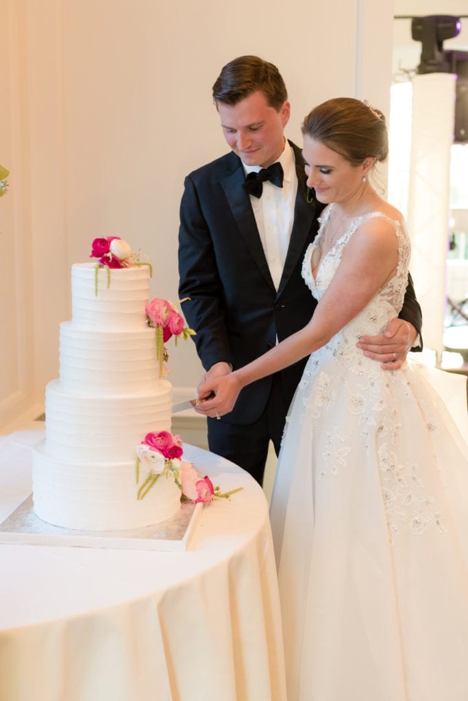 bride and groom cutting their cake