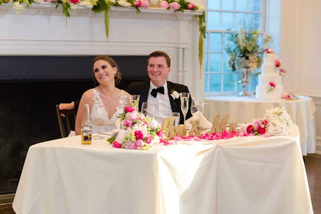 bride and groom listening to speeches 