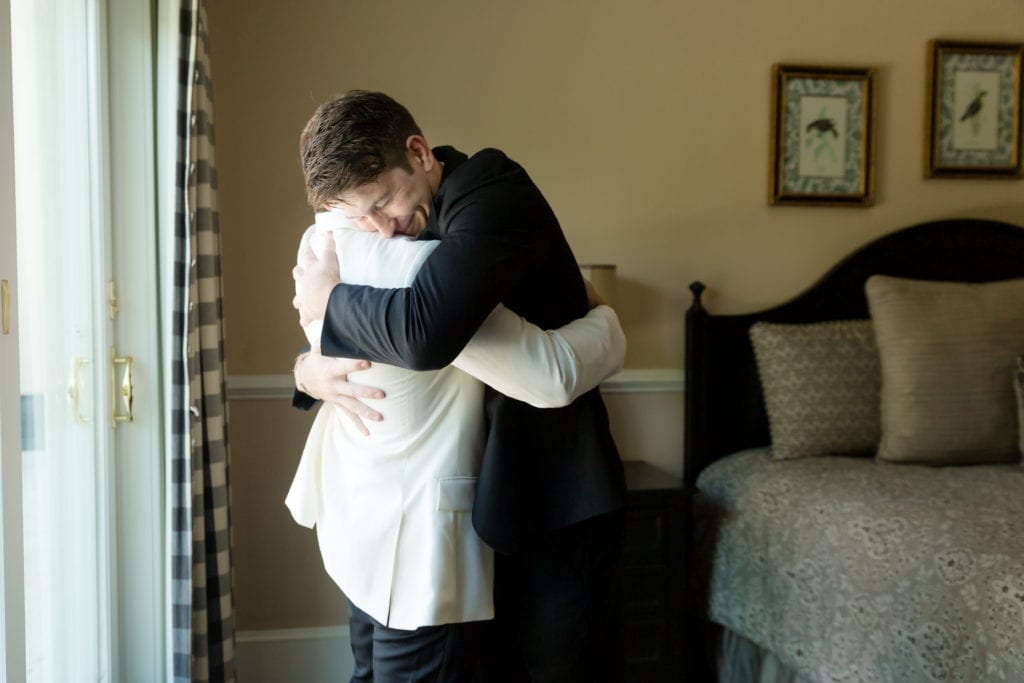 groom hugging groomsmen on his wedding day