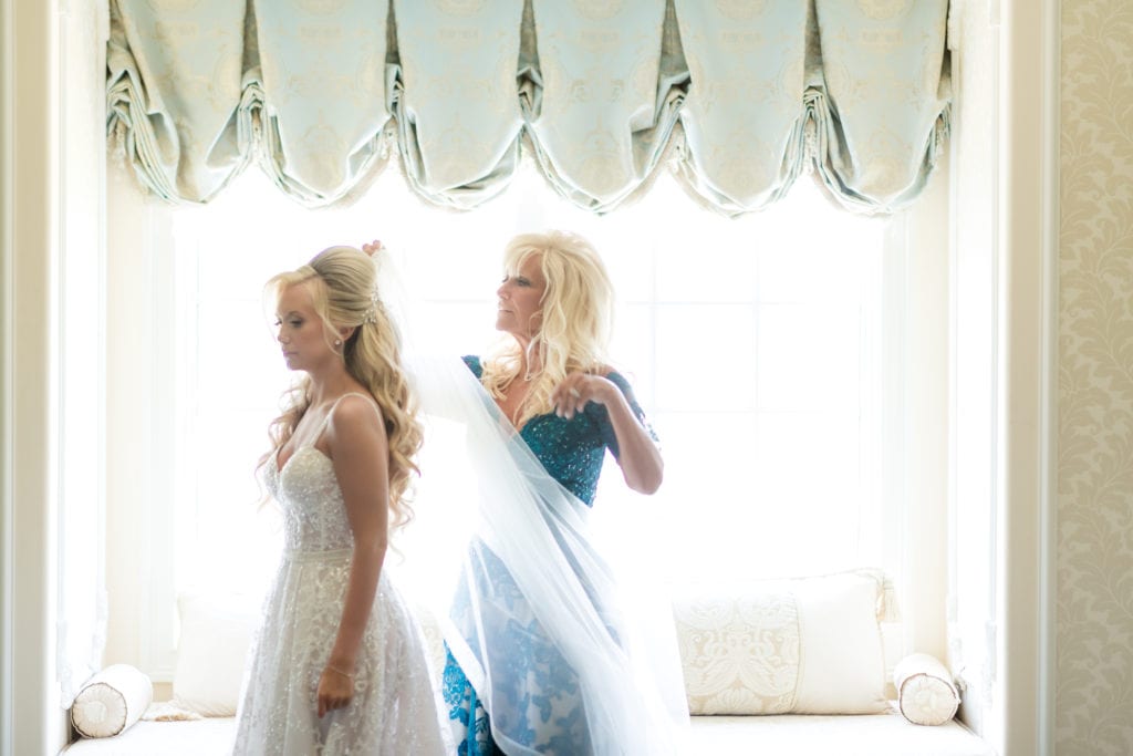 brides mother putting on her veil, bridal day preparations 