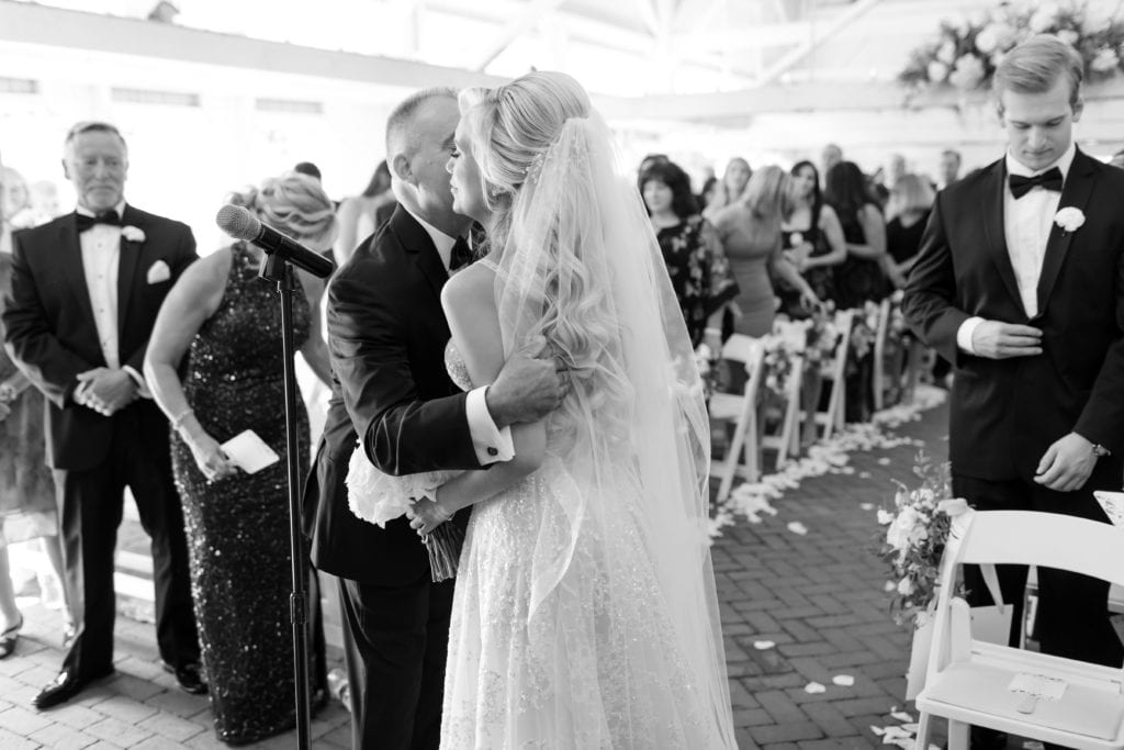 father giving his daughter away at the alter, black and white wedding photography