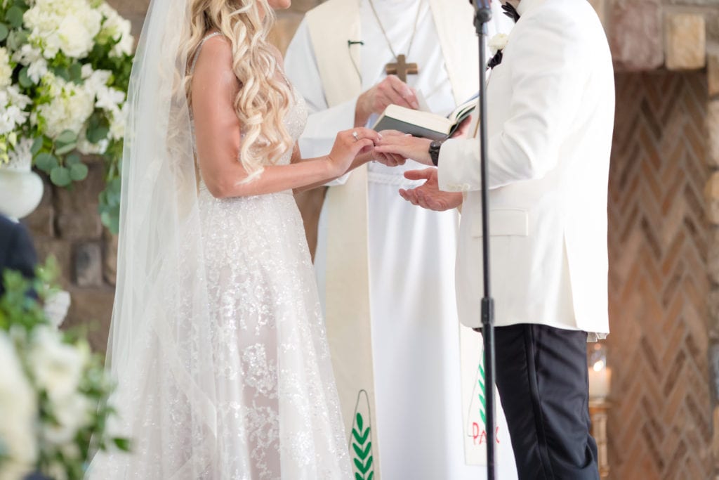 bride and groom exchanging rings