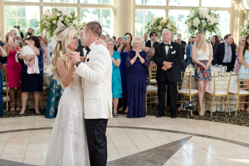 bride and grooms first dance, guests watching bride and groom dance