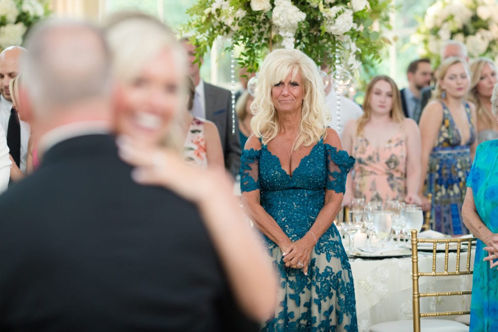 mother watching her daughter and husband dance