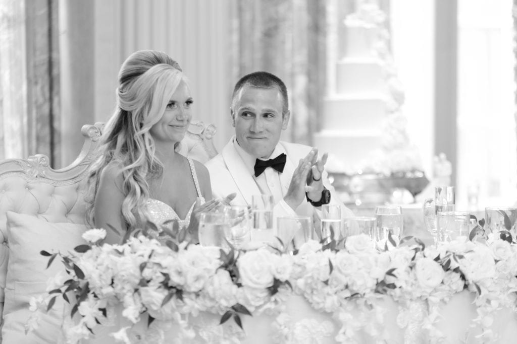 bride and groom listening to speeches