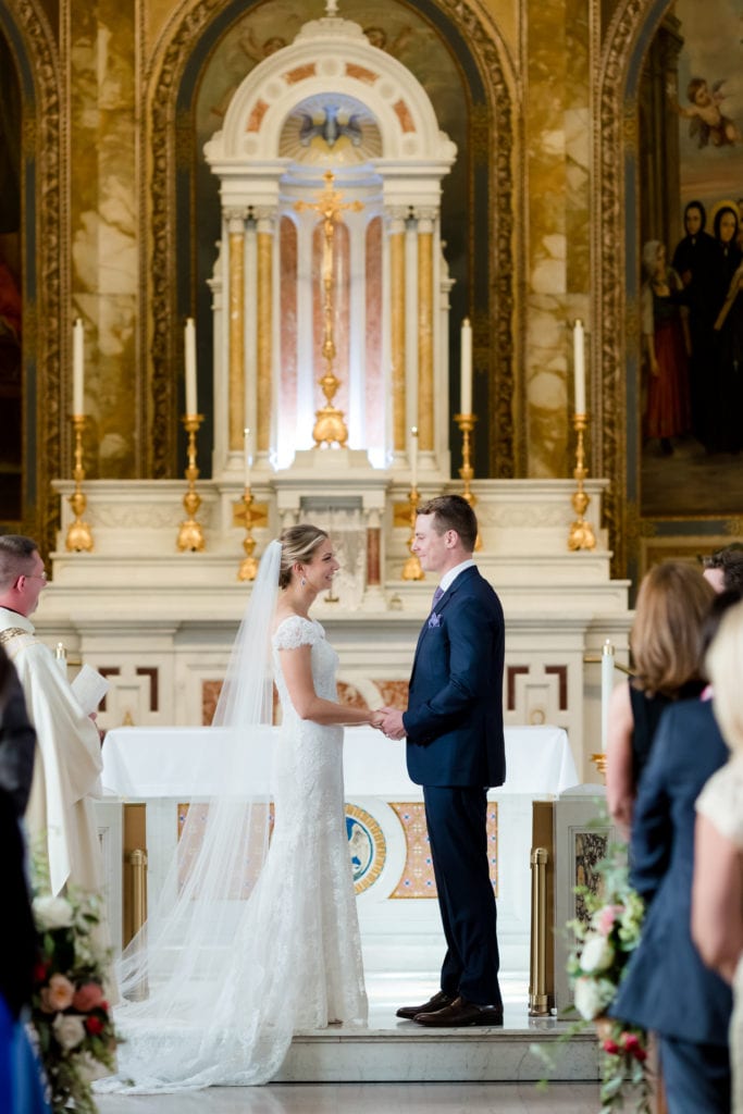 bride and groom at alter