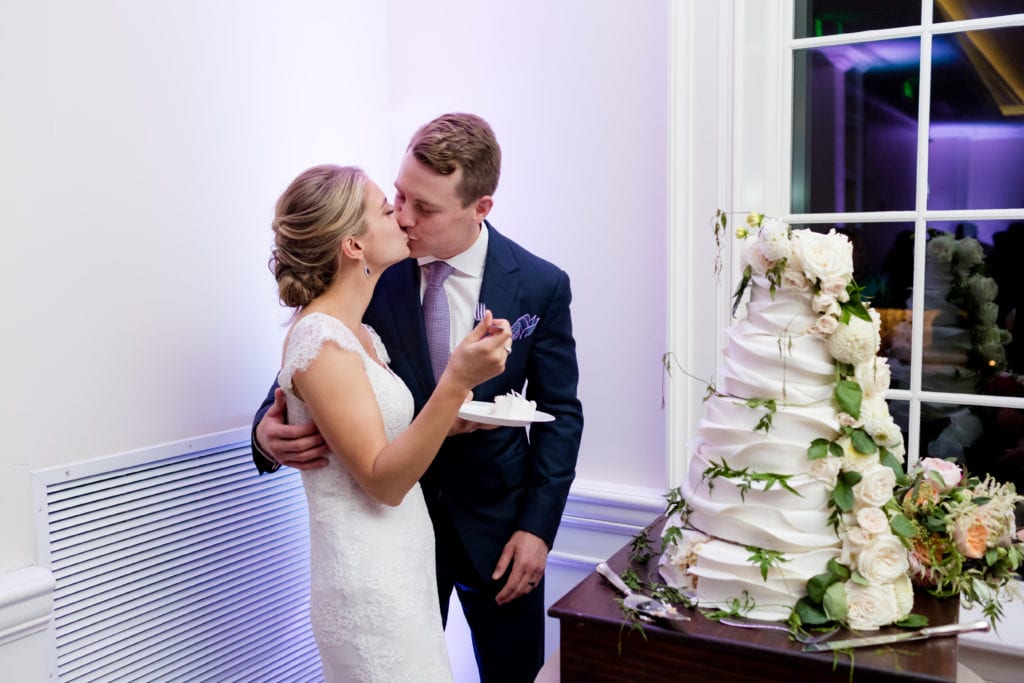 bride and groom cutting the artist baker cake