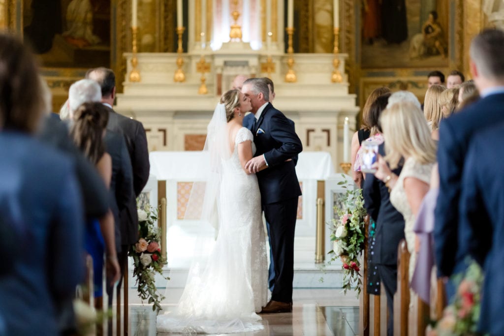 father giving his daughter away at the alter