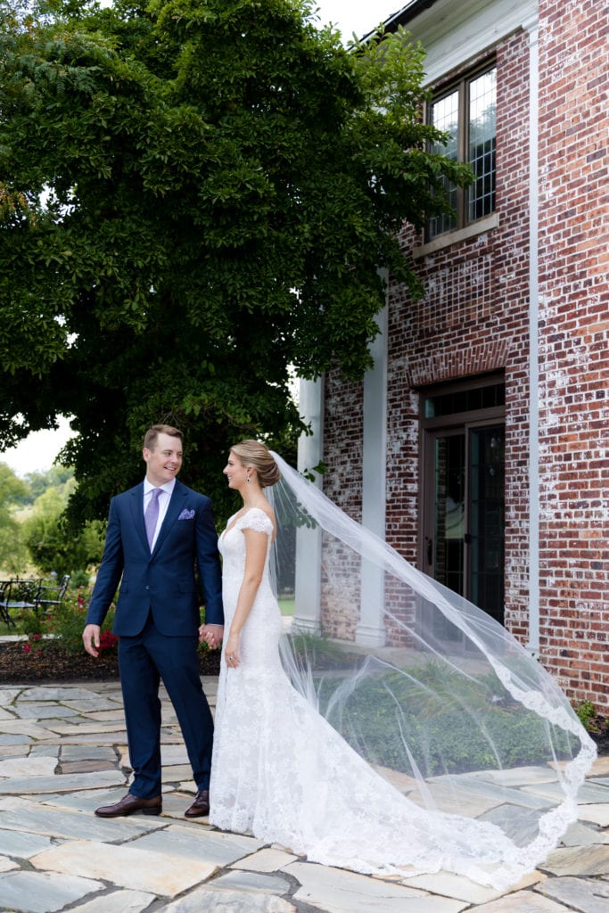 Monique Lhuillier wedding dress, veil blowing in the wind