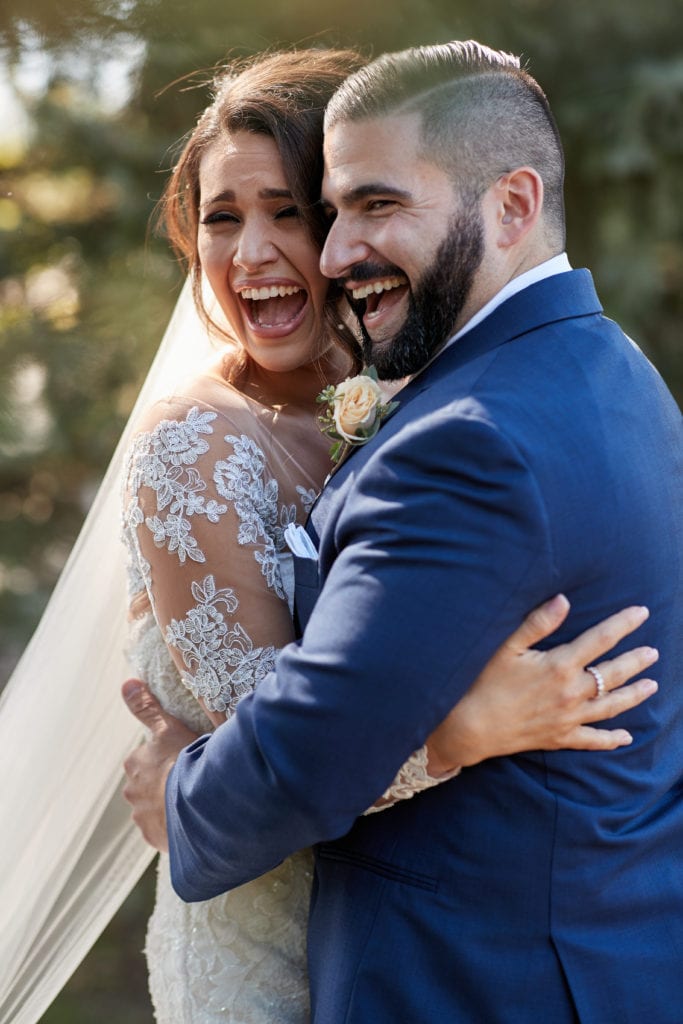 bride and groom laughing on wedding day