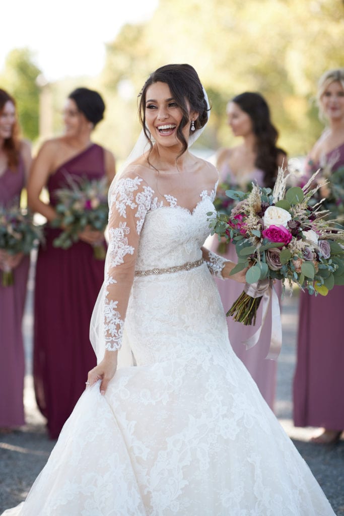 bride laughing with her bridesmaids, Pronovias wedding dress