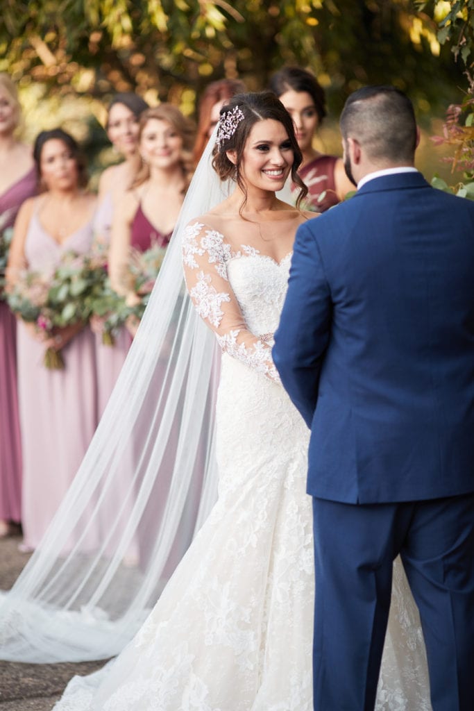 bride with her bridesmaids at alter 