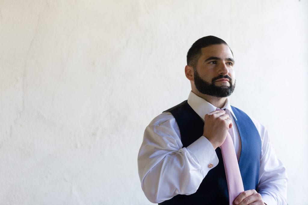 pink tie with blue suit