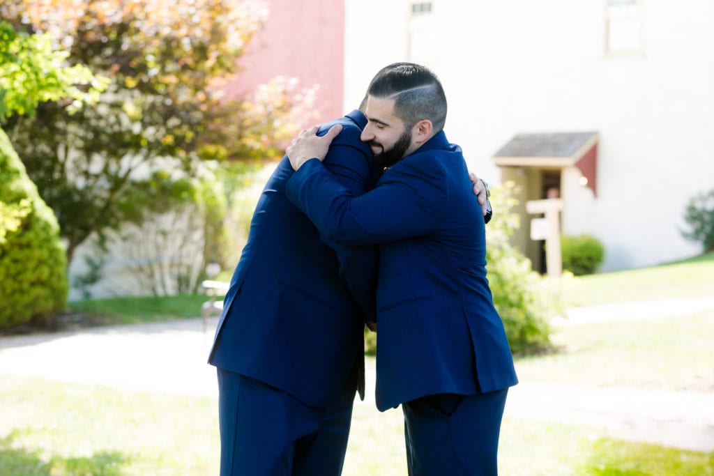 groom and groomsmen embracing