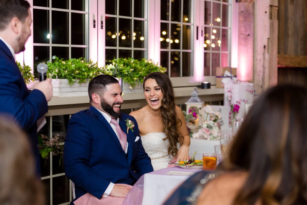 bride and groom laughing at speeches