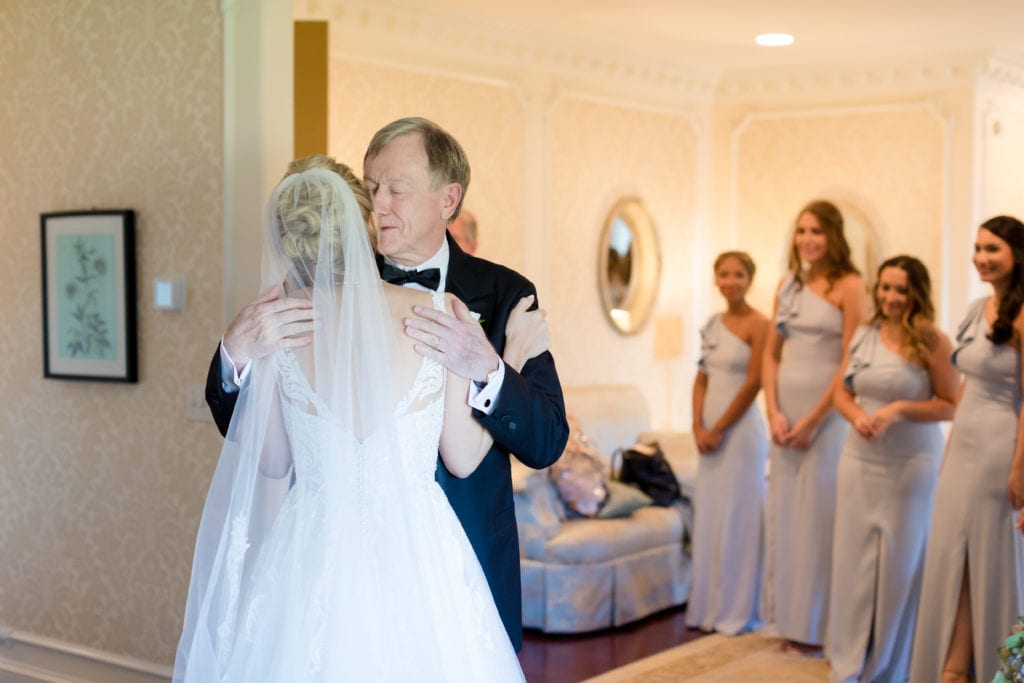 father and bride embrace