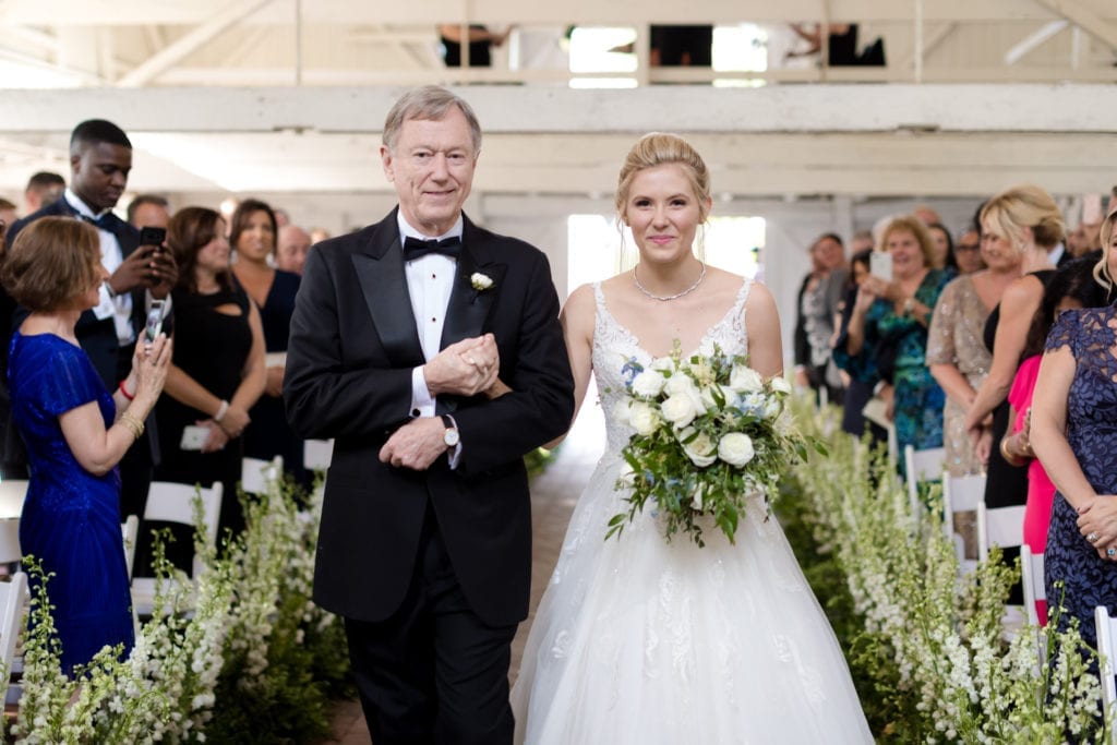 father of the bride walking his bride down aisle