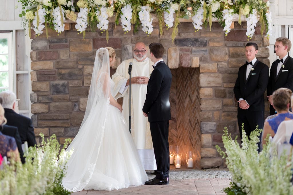 the bride and groom exchanging their vows