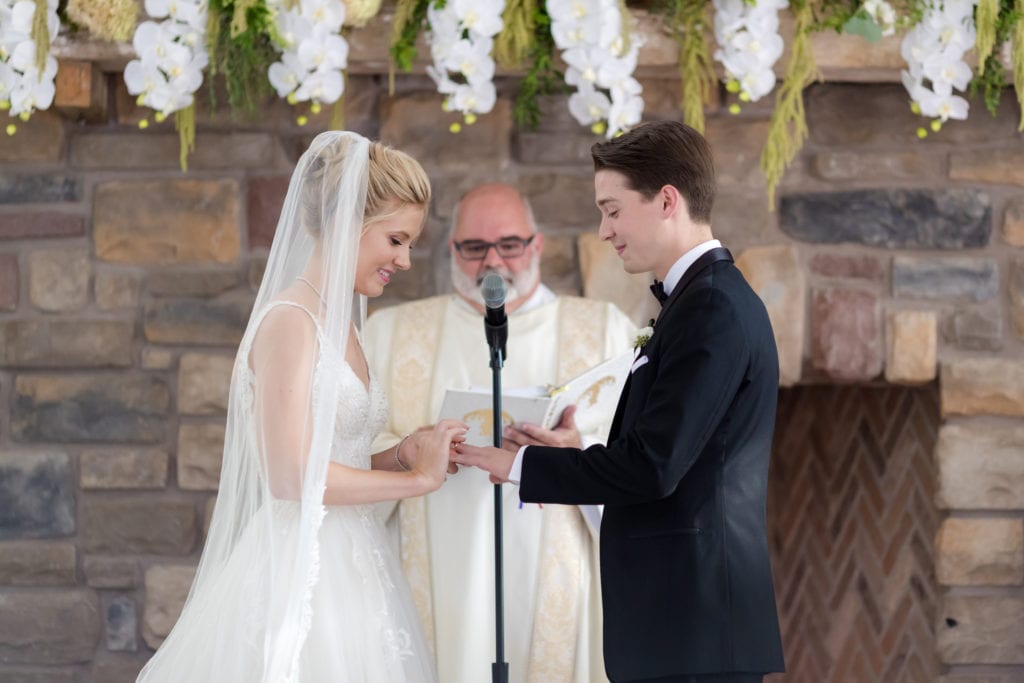 bride and groom exchanging rings