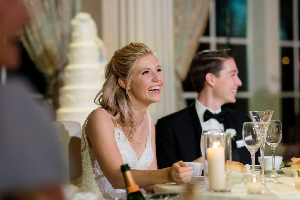 bride and groom listening to speeches