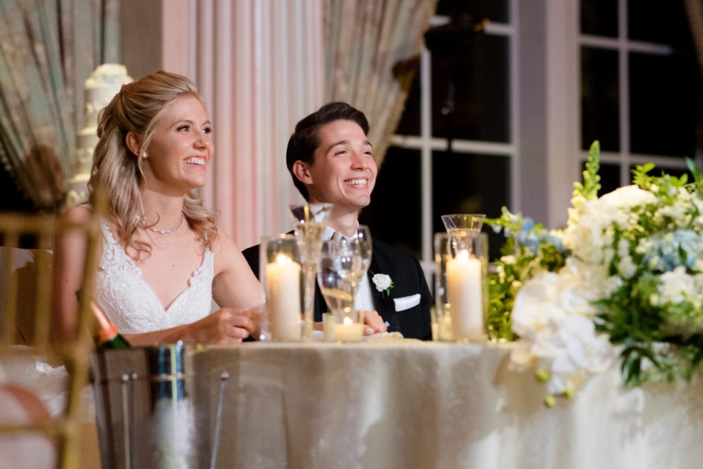 bride and groom listening to wedding speeches 