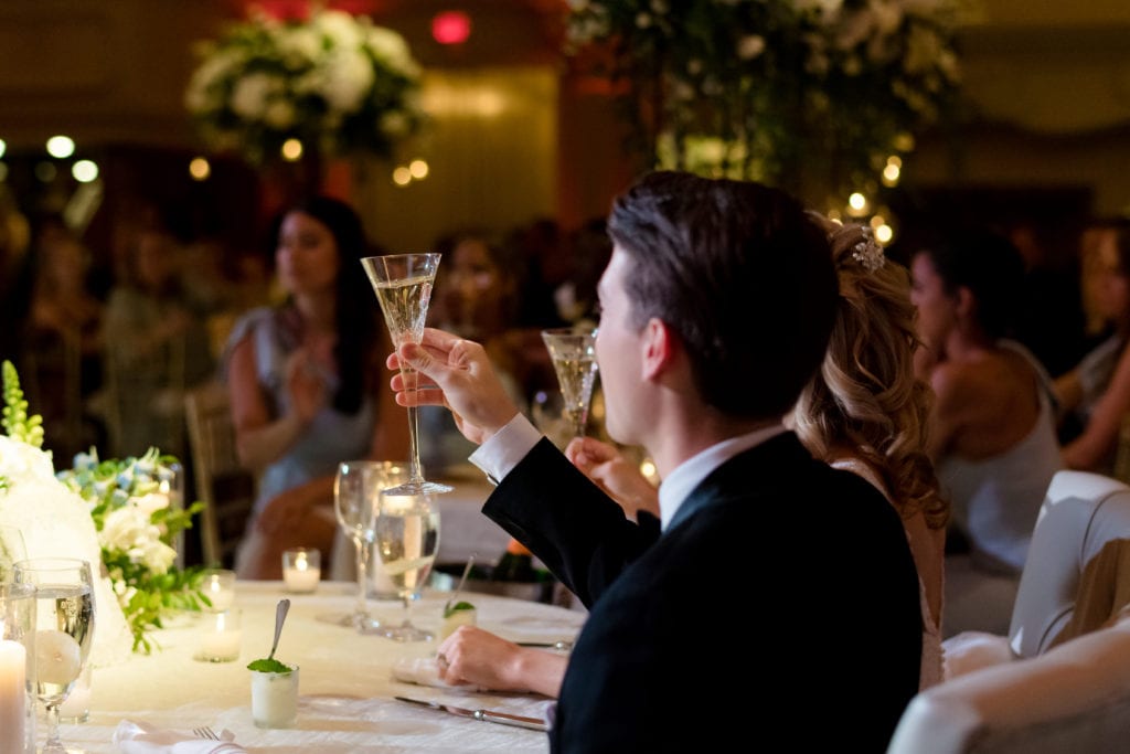 bride and groom toasting at wedding 