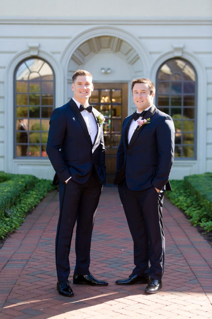 groom and groomsmen in black and navy tuxedos from The Black Tux