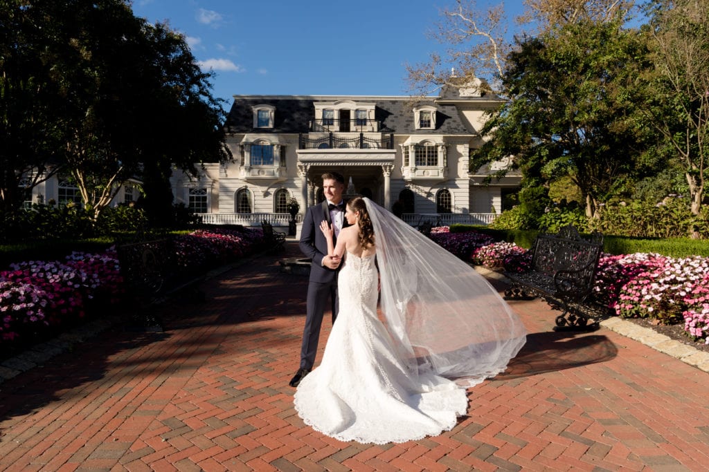 brides veil blowing in front of Ashford Estate