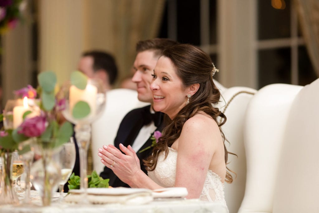 bride and groom listening to speeches