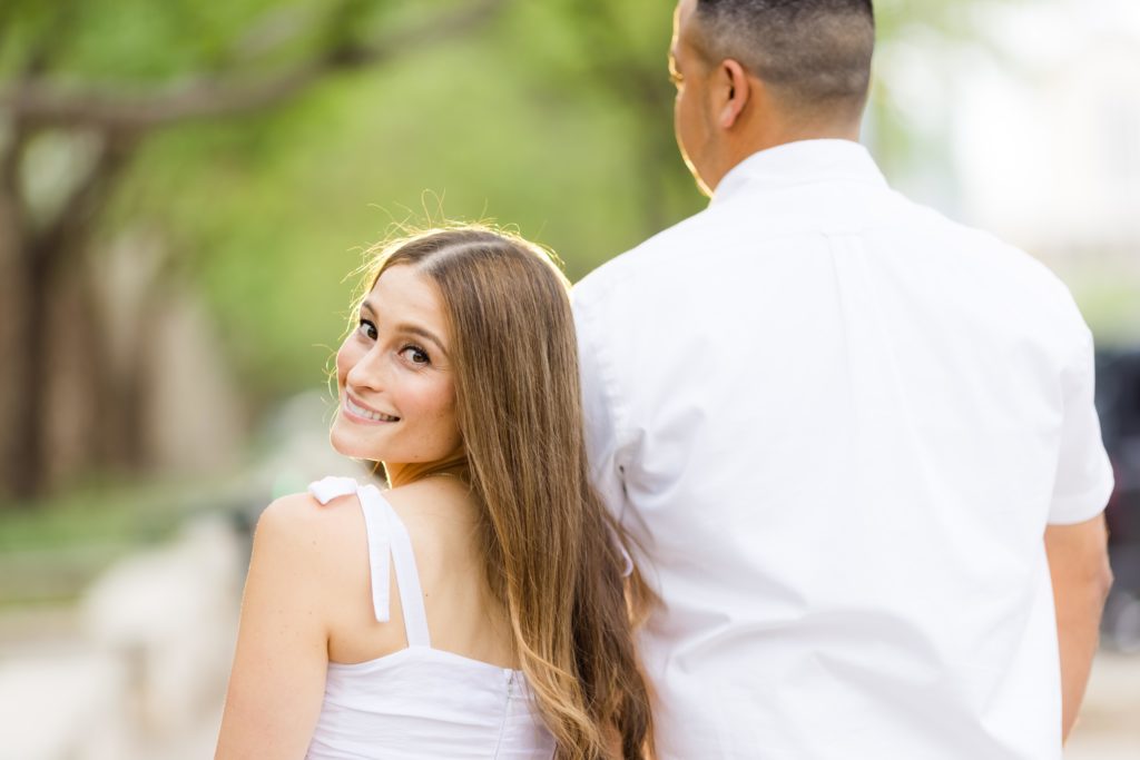 Fiance looking over shoulder, blurred background