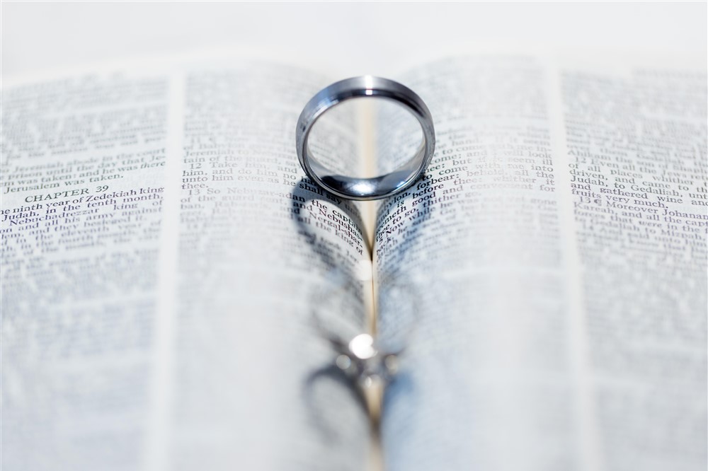 love heart wedding ring and bands in book. Photo by Vanessa Joy Photography.