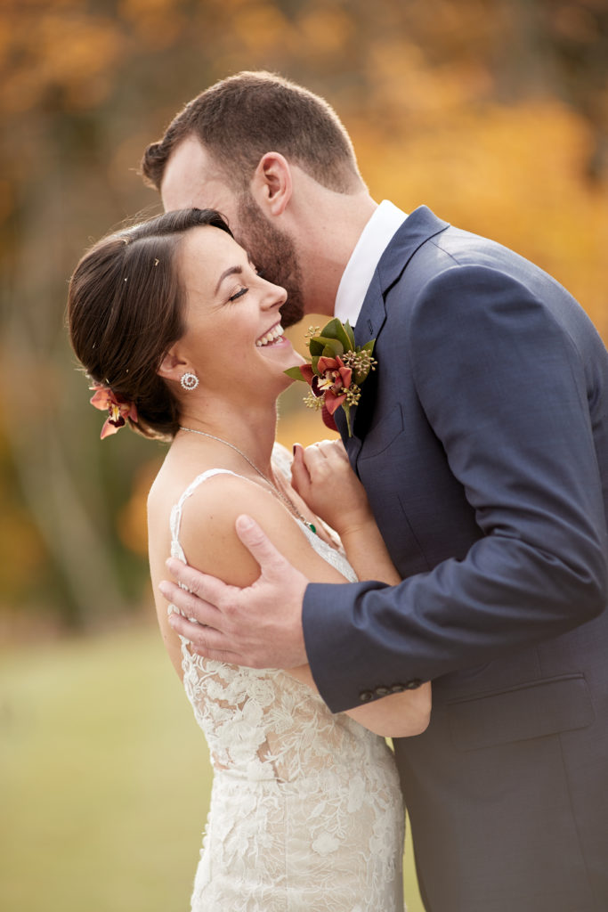 bride and groom portrait on wedding day laughing and smiling. Photo by Vanessa Joy Photography