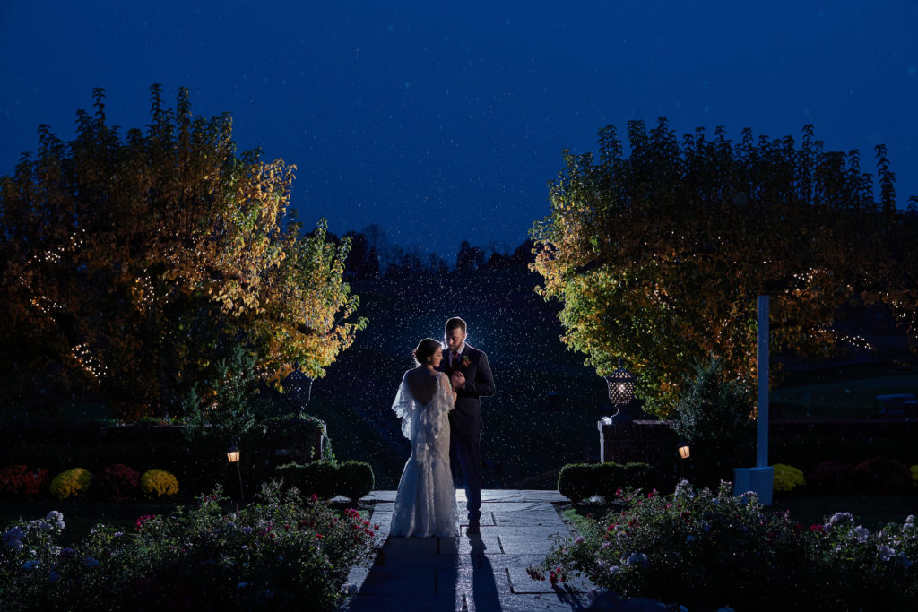 Dusk Night twilight photo of bride and groom rain on wedding day. Photo by Vanessa Joy photography