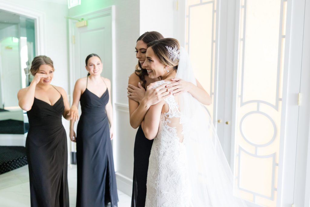 Bridesmaid hugs bride, bridal preparations