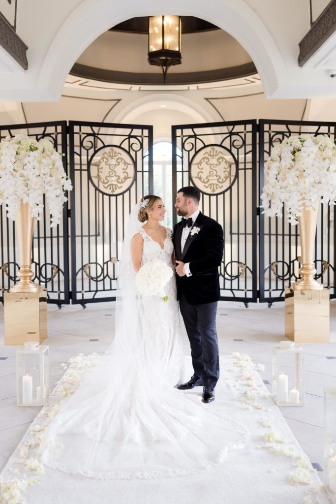 bride and groom gaze in each other's eyes in the wedding hall at the Shadowbrook At Shrewsbury mansion