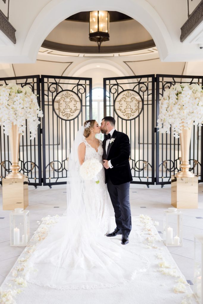 bride and groom kiss at their wedding hall venue in Shadowbrook At Shrewsbury