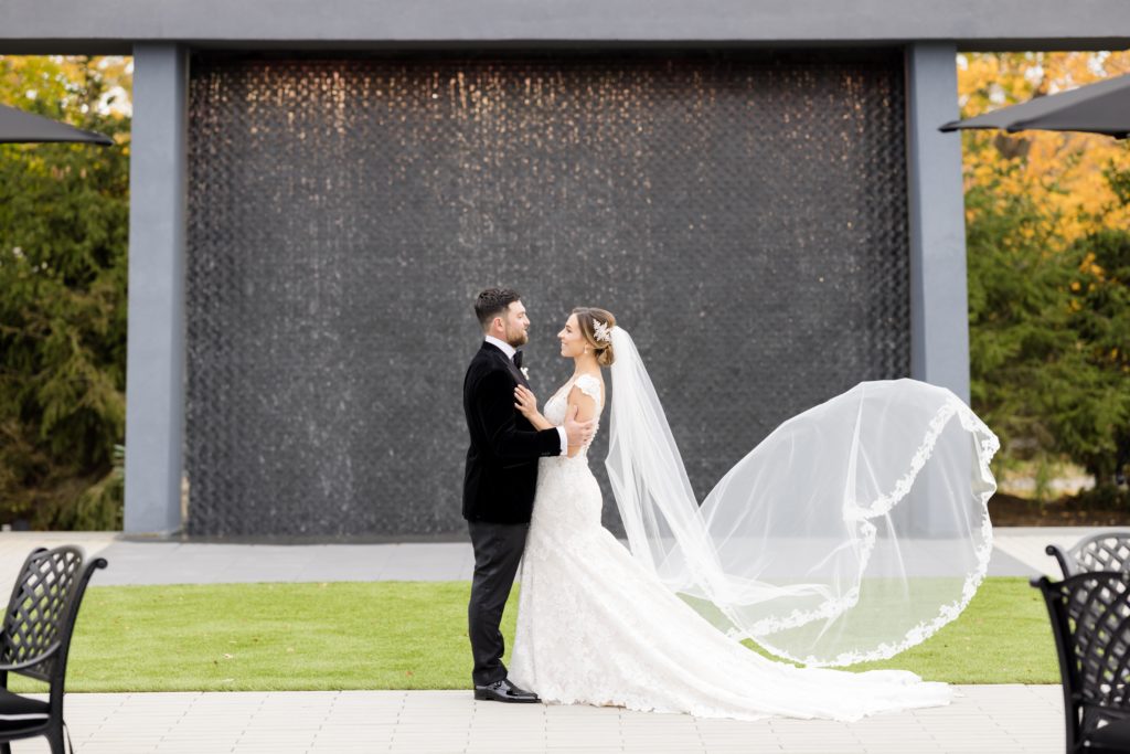 wedding portraits, Maggie Sottero Designs wedding gown, lace-edged veil, classic tux