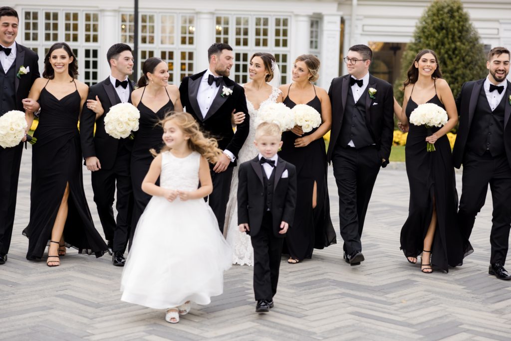 Flower boy and flower girl, wedding entourage in front of the mansion in the Shadowbrook At Shrewsbury