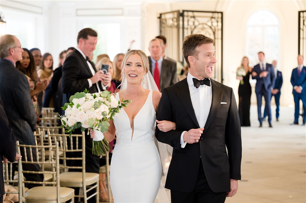 just married bride and groom walking down the isle