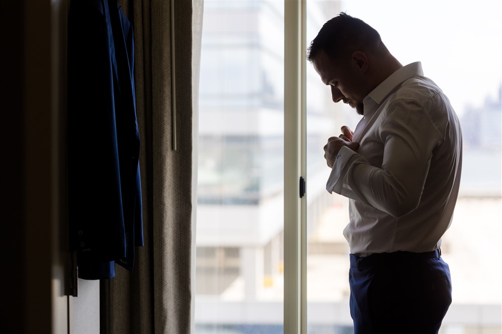 silhouette photo groom getting ready