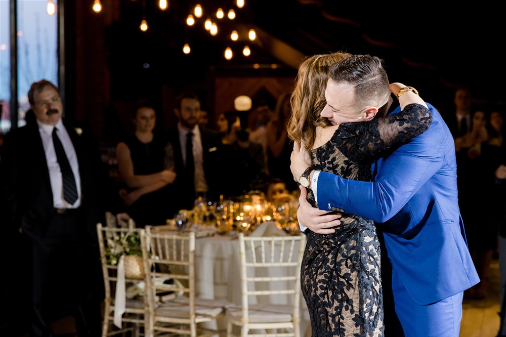 groom and mother dance hug